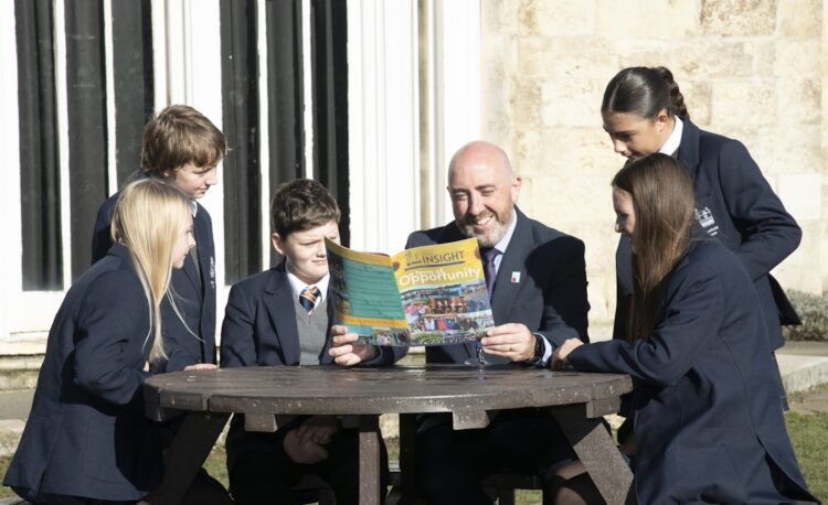 The Headteacher reading with students.